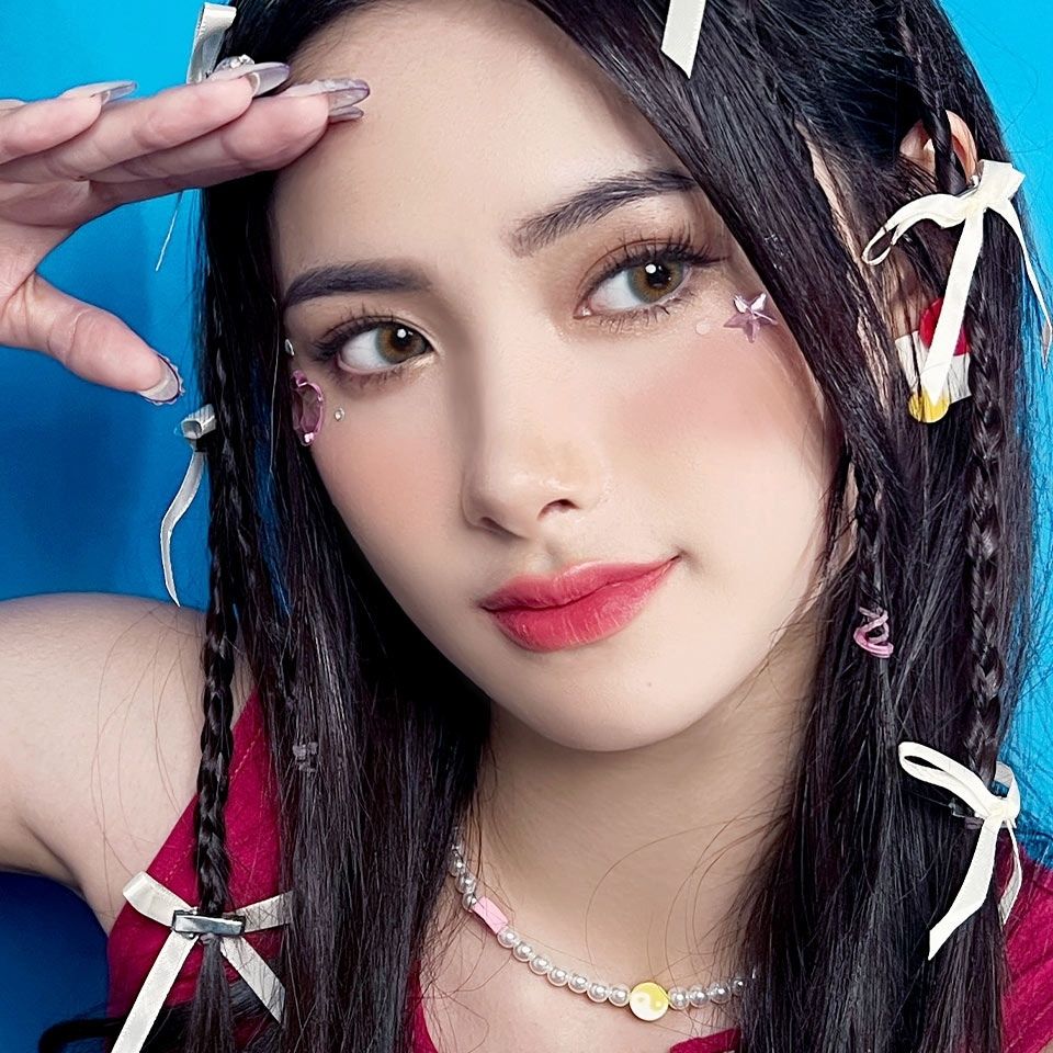 Model wearing Aqua Playday contact lenses with soft aqua and hazel tones, creating a fresh, youthful, and natural eye enhancement.