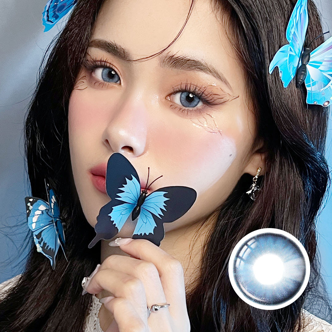Model wearing Pretty Blue Affair contact lenses with blue butterflies, creating a dreamy look with soft blue lenses and matching accessories.