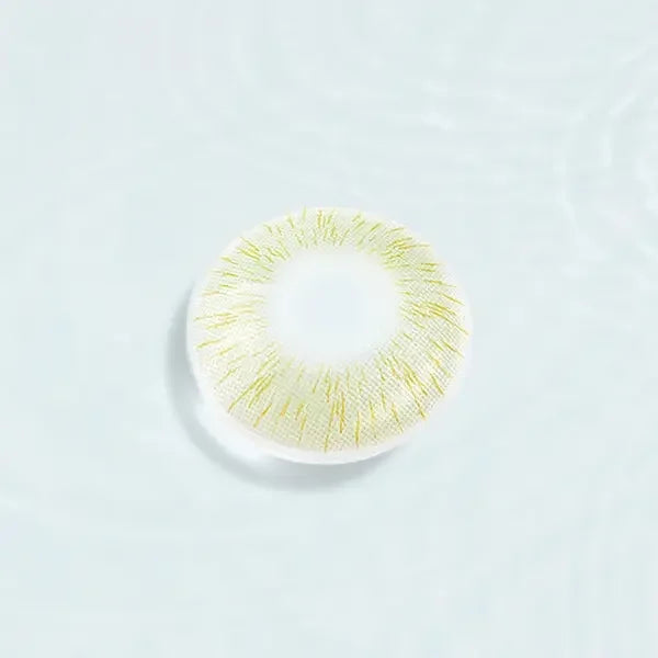 Single Perfect Hue Meloni Green lens displayed against a water-like background, emphasizing the unique green and yellow pattern.