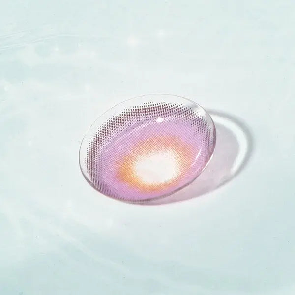 Single Say Yes Nightout Violet lens displayed in water, focusing on its deep violet color and glowing golden accents.