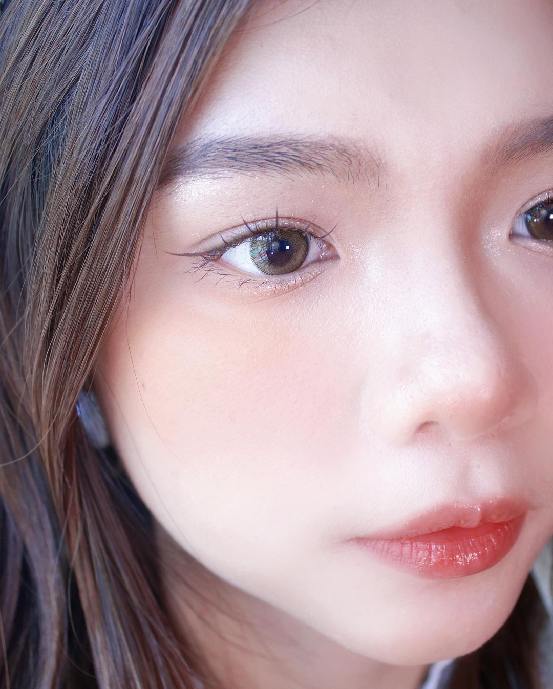 Close-up of a woman wearing  honeycolor better be so lo brown lenses