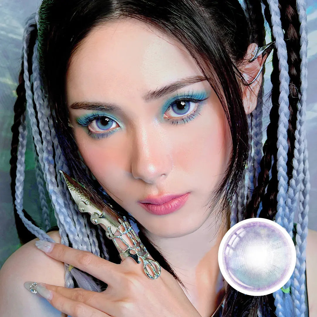 Model wearing Metafantasia Blue contact lenses with fantasy-inspired makeup and accessories, showcasing bold and vibrant eye color.