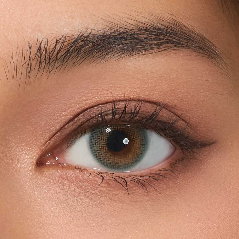 Close-up of eye wearing VISKON Aqua Playday lenses with natural hazel-brown effect