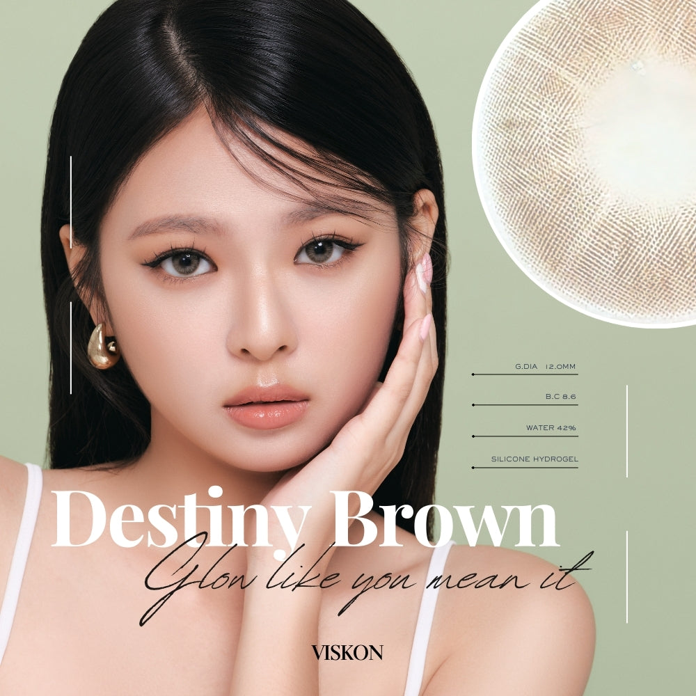 Model wearing VISKON Destiny Brown contact lenses, featuring soft warm brown tones with a subtle glow