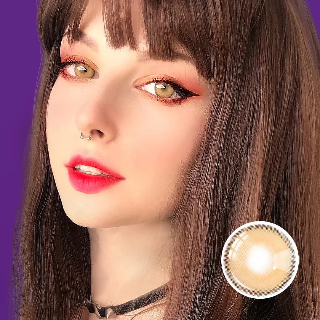 Close-up portrait of a model with Say Yes Crush Brown lenses, complemented by sharp eyeliner and warm golden tones in the makeup. 